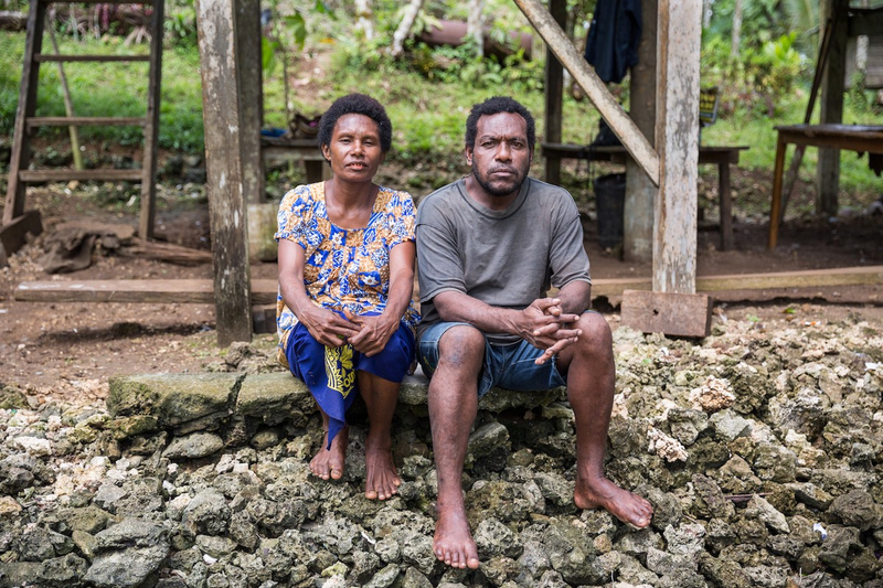 Paul Pavol and his wife, Janet Pavol, in front of their house in the village of Mu, Pomio District, New Britain, Papau New Guinea. Source: Global Witness